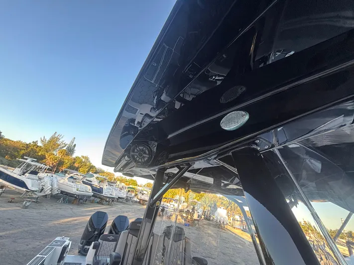  Yacht Photos Pics 2022 Fountain 38 SC boat with sleek design and powerful engines in a marina setting.