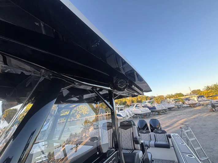  Yacht Photos Pics 2022 Fountain 38 SC boat with sleek design, docked under clear blue sky.