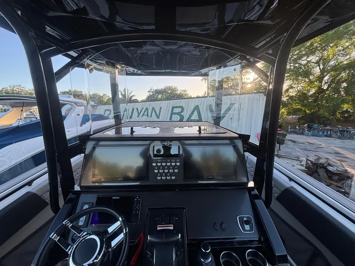  Yacht Photos Pics 2022 Fountain 38 SC boat dashboard with modern controls and steering wheel.