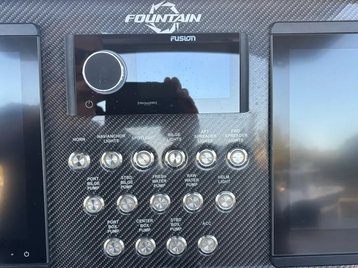  Yacht Photos Pics Control panel of 2022 Fountain 38 SC boat with various switches and Fusion audio system.