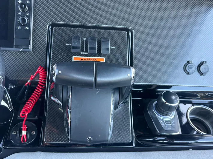  Yacht Photos Pics Control panel of a 2022 Fountain 38 SC boat with throttle and switches.