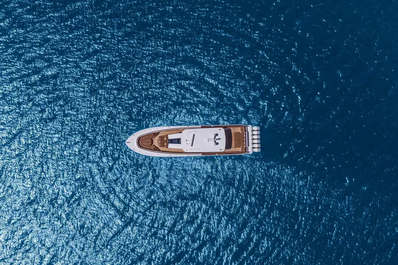 Big Momma Yacht Photos Pics Aerial view of 2023 HCB 65 Estrella yacht on blue ocean water.