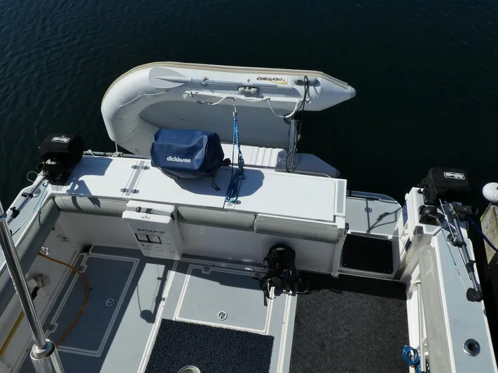 Morning Star V Yacht Photos Pics 1997 Albin 31 Tournament boat deck with mounted dinghy and fishing equipment.