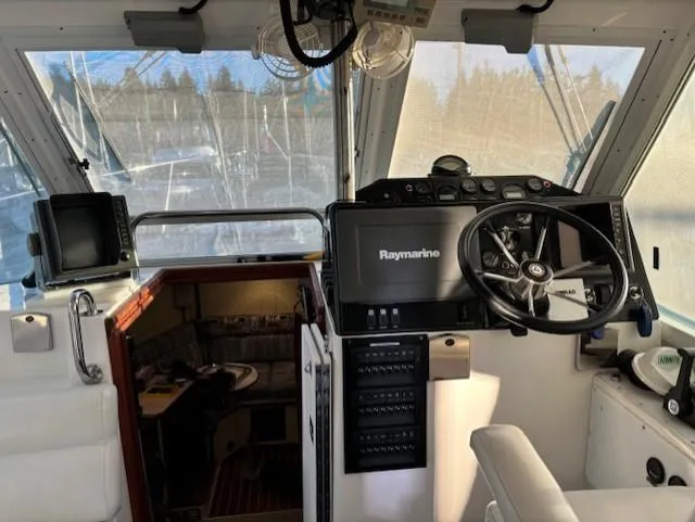 Morning Star V Yacht Photos Pics 1997 Albin 31 Tournament boat cockpit with steering wheel and navigation equipment.