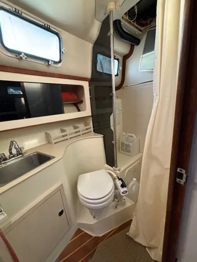 Morning Star V Yacht Photos Pics 1997 Albin 31 Tournament boat bathroom with sink, toilet, and shower.