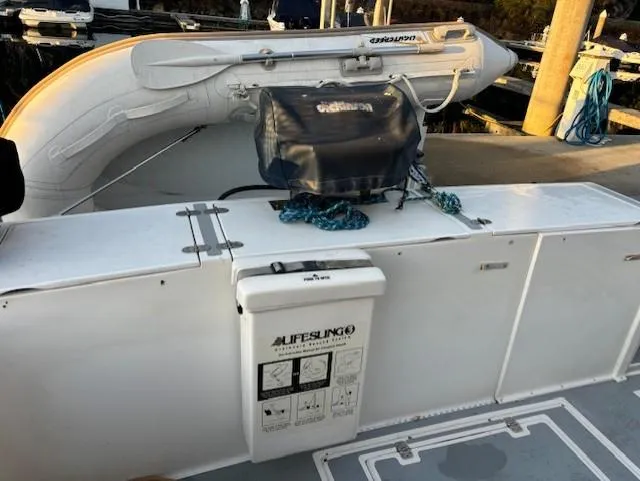 Morning Star V Yacht Photos Pics 1997 Albin 31 Tournament boat deck with lifebuoy and inflatable dinghy.