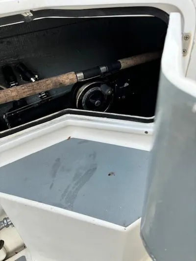 Morning Star V Yacht Photos Pics Storage compartment of a 1997 Albin 31 Tournament boat with fishing rod inside.