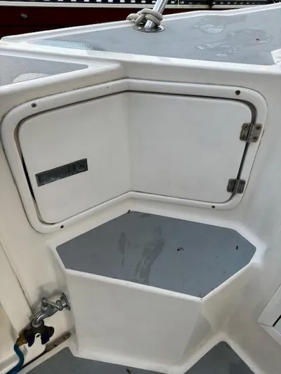 Morning Star V Yacht Photos Pics 1997 Albin 31 Tournament boat storage compartment with white finish and metal hinges.