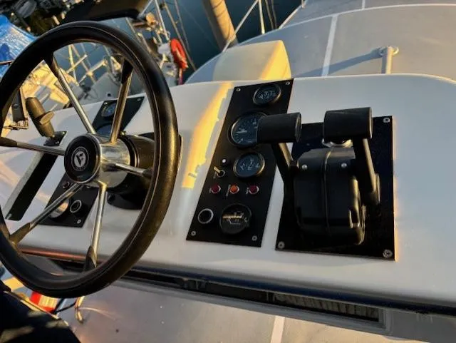 Morning Star V Yacht Photos Pics Steering wheel and controls of a 1997 Albin 31 Tournament boat at sunset.