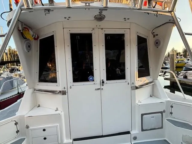 Morning Star V Yacht Photos Pics 1997 Albin 31 Tournament boat stern view with white cabin doors and windows.