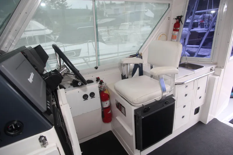 Morning Star V Yacht Photos Pics Interior of a 1997 Albin 31 Tournament boat with helm, seat, and storage.