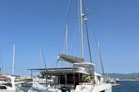 2018 Leopard 45 catamaran docked in a marina under clear blue skies.