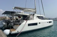 2018 Leopard 45 catamaran docked in a marina, featuring a spacious deck and modern design.