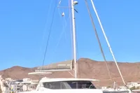 2018 Leopard 45 catamaran docked with clear blue sky and hills in background.