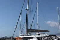 2018 Leopard 45 catamaran docked at marina under clear blue sky.