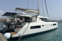 2018 Leopard 45 catamaran docked in a marina, featuring solar panels and twin outboard motors.