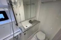 Modern bathroom in 2018 Leopard 45 yacht with shower, sink, and toilet.