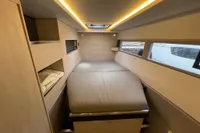 Luxurious interior of 2018 Leopard 45 yacht cabin with modern lighting and comfortable bedding.