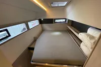Interior of 2018 Leopard 45 yacht cabin with bed and windows.