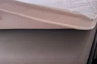 Close-up of a mattress corner with a white quilted cover, Leopard 45, 2018 model.