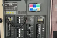 Electrical panel of a 2018 Leopard 45 yacht with digital display and warning labels.