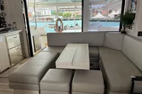 Luxurious interior of 2018 Leopard 45 yacht with modern seating and scenic marina view.