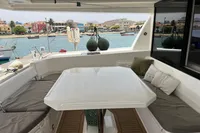 Luxurious Leopard 45 yacht interior with comfortable seating, docked by scenic waterfront.