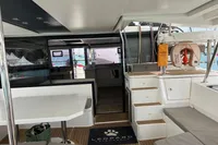 2018 Leopard 45 catamaran interior with seating, steps, and marina view.