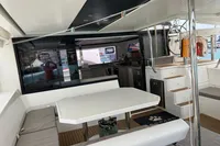 Interior view of 2018 Leopard 45 catamaran, featuring dining area and helm station.