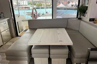 Luxurious interior of a 2018 Leopard 45 yacht with a cozy dining area.