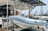 2018 Leopard 45 yacht with solar panels and a Highfield tender at the dock.