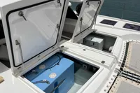 Open storage compartments on a 2018 Leopard 45 catamaran, revealing equipment and blue tank.