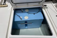 Open storage compartment on 2018 Leopard 45 yacht, featuring a blue water tank.