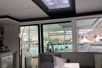 Interior view of a 2018 Leopard 45 catamaran with marina backdrop.