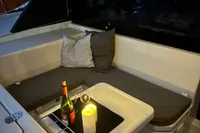 Cozy seating area on 2018 Leopard 45 yacht with wine and candles.