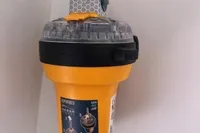 Yellow EPIRB device mounted on a wall, featuring a clear top and instructional label.