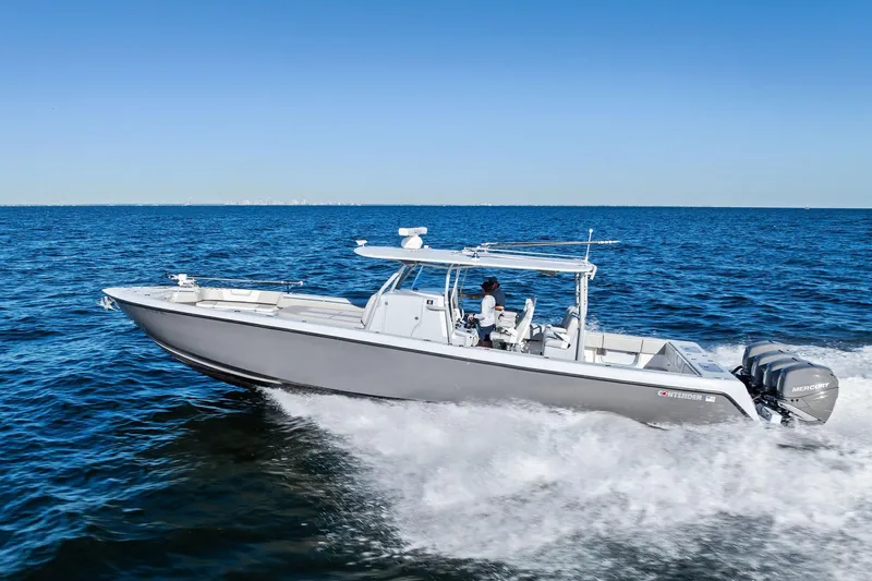  Yacht Photos Pics 2022 Contender 44 CB boat cruising on open water with clear blue sky.