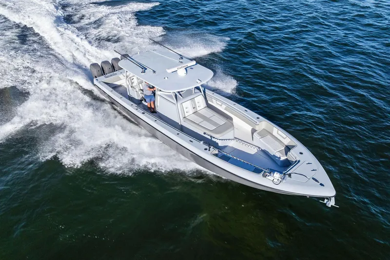  Yacht Photos Pics 2022 Contender 44 CB boat cruising on open water, showcasing sleek design and powerful engines.