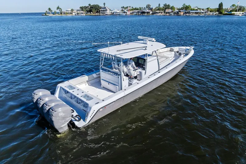  Yacht Photos Pics 2022 Contender 44 CB boat with triple outboard engines on open water.