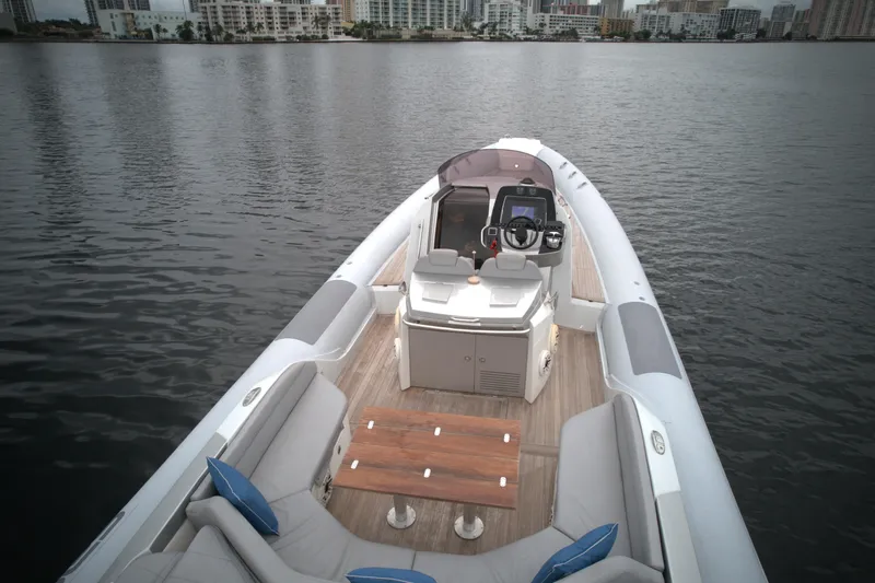  Yacht Photos Pics 2014 SACS Strider 13 boat with seating and control console on calm water.