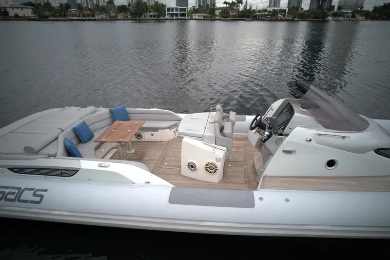  Yacht Photos Pics 2014 SACS Strider 13 luxury boat with spacious deck and seating on calm water.