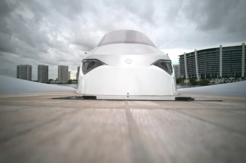  Yacht Photos Pics Front view of 2014 SACS Strider 13 yacht docked with cityscape background.