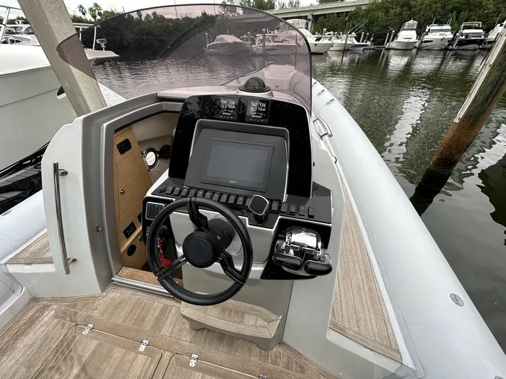  Yacht Photos Pics 2014 SACS Strider 13 boat helm with steering wheel and navigation system.