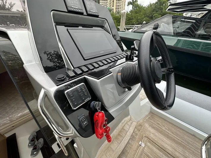  Yacht Photos Pics 2014 SACS Strider 13 boat dashboard with steering wheel and control panel.