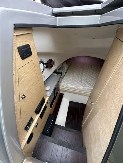  Yacht Photos Pics Interior cabin of a 2014 SACS Strider 13 boat with bed and control panel.