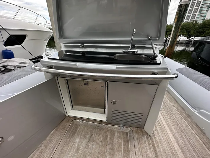  Yacht Photos Pics Outdoor kitchenette on a 2014 SACS Strider 13 yacht with a sink and storage.