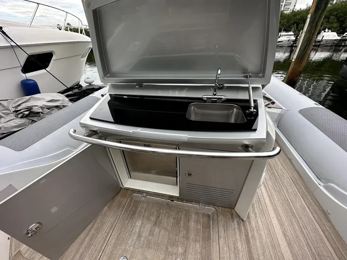  Yacht Photos Pics 2014 SACS Strider 13 boat with open storage compartment and sink.