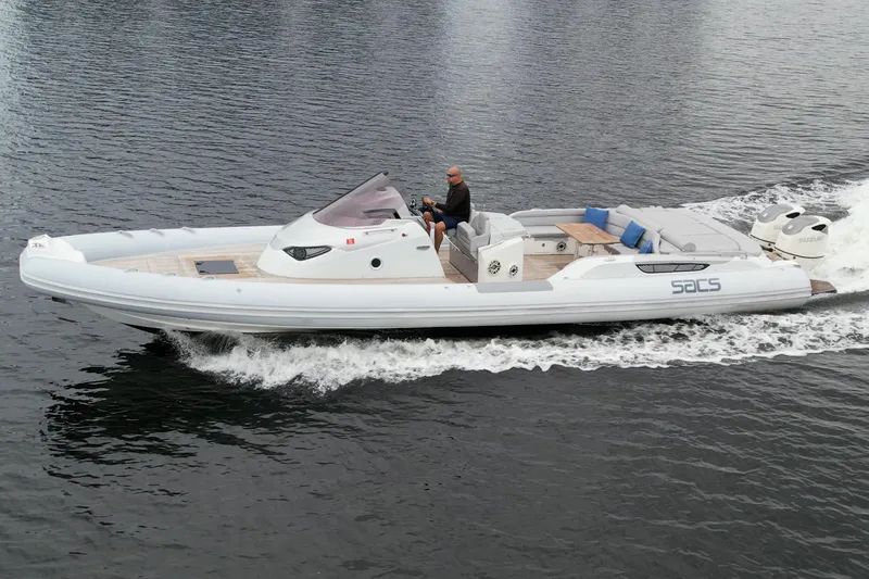  Yacht Photos Pics 2014 SACS Strider 13 boat cruising on water.