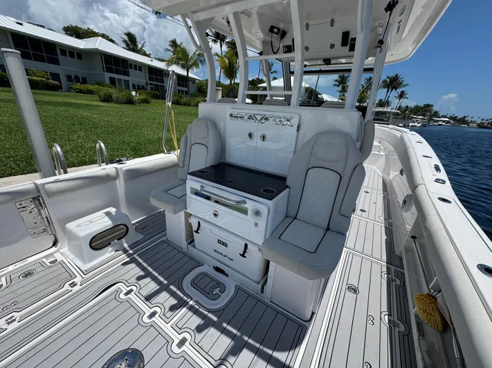  Yacht Photos Pics 2023 Sea Fox 368 Commander boat interior with seating and console, docked by waterfront homes.