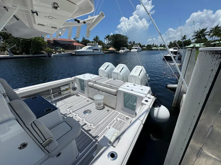  Yacht Photos Pics 2023 Sea Fox 368 Commander docked, showcasing spacious deck and triple outboard engines.